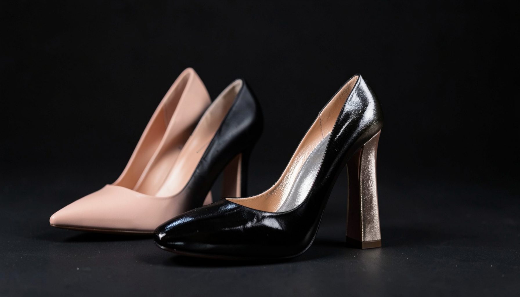 Elegant stiletto and block heels in blush, black, and metallic tones, softly lit against a dark backdrop