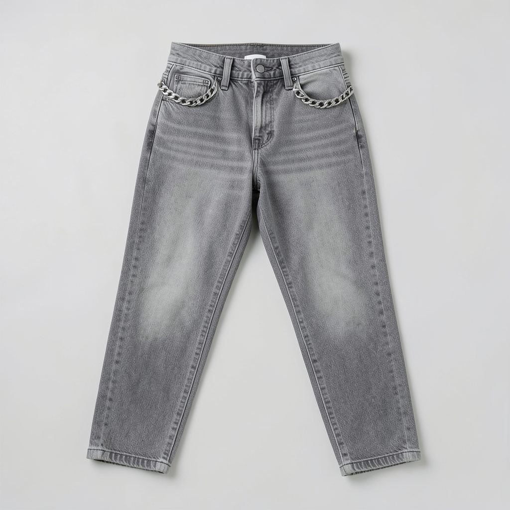 Pair of washed grey mom jeans with a chain waist detail laid flat against a plain light background